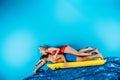 young couple in swimwear swimming on inflatable mattress Royalty Free Stock Photo