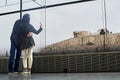 Young couple take picture with a mobile the Acropolis in Athens.