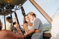 A young couple taken pictures in a hot air balloon