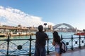 Young couple taking pictures of Harbour Bridge in Sydney, Australia. Royalty Free Stock Photo