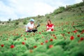 Young couple taking selfie on a meadow of wild peonies outdoors. Royalty Free Stock Photo