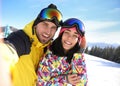 Young couple taking selfie at ski resort. Winter vacation Royalty Free Stock Photo