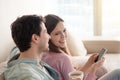 Young couple talking, laughing sitting indoors, leisure time, si Royalty Free Stock Photo