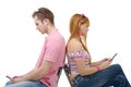 Young couple talking on mobile phones sitting back to back. Royalty Free Stock Photo