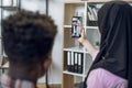 Young couple talking with muslim friends during video call Royalty Free Stock Photo