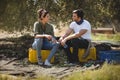 Young couple talking while sitting at olive farm Royalty Free Stock Photo