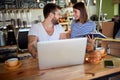 Young couple talking and smiling, having breakfast in coffe shop thet they are about to open. Starting business