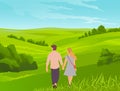 Young couple or teenagers walk hand in hand through the green valley. Bushes and grass on background