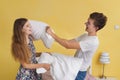 Young couple teens , pillow fight