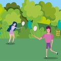 Young couple with tennis rackets in the park cartoon Royalty Free Stock Photo