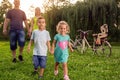 young couple with their children have fun at beautiful park outdoor in nature. Royalty Free Stock Photo