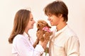 Young couple with their cute ginger poodle puppy.