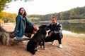 A young couple with their Dog in Autumn park. Royalty Free Stock Photo