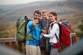 A young couple and their son taking selfie on the top of a watchtower in the forest