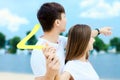 Young couple throwing boomerang. Summer outdoor activities