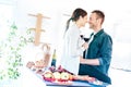 Young couple toasting red wine and almost kissing at home kitchen - Happy millenial lovers enjoying tender moment cheering Royalty Free Stock Photo