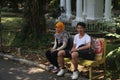 Young couple together on a bench in the Botanical Garden