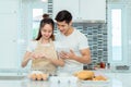 Young couple together cooking, Woman first crack an egg Royalty Free Stock Photo