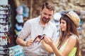 Young couple of tourists buying new sunglasses in street stall outdoor