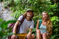 Young couple tourists are resting on the rocks in the jungle Royalty Free Stock Photo