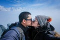 Young Couple Tourists selfie kiss with mobile phone near view of the Swiss Skyline from Schilthorn, Switzerland Royalty Free Stock Photo