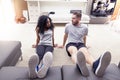 Young couple are training doing gymnastics at home