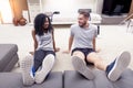 Young couple are training doing gymnastics at home