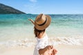 Young couple traveler holding hands relaxing and enjoying at beautiful tropical white sand beach with wave foam and transparent Royalty Free Stock Photo