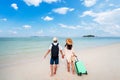 Young couple traveler with luggage relaxing and enjoying at beautiful tropical sand beach, Summer vacation and Travel Royalty Free Stock Photo