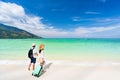 Young couple traveler with luggage relaxing and enjoying at beautiful tropical sand beach, Summer vacation and Travel Royalty Free Stock Photo