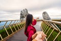 Young couple traveler in red dress enjoying at Golden Bridge in Bana hills, Danang Vietnam Royalty Free Stock Photo