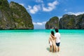 Young couple traveler relaxing and enjoying at beautiful tropical white sand beach at Maya bay in Krabi, Thailand Royalty Free Stock Photo