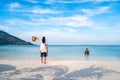 Young couple traveler relaxing and enjoying at beautiful tropical white sand beach with transparent sea, Summer vacation Royalty Free Stock Photo