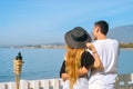 Young couple of travelers beackground sea or ocean. Happy loving couple on summer tropical beach. Vacation, tourism, hooneymoon Royalty Free Stock Photo