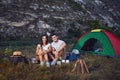 Romantic camping. A young couple sitting by the bonfire