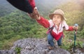 Young couple traveling, Helping hand, hiker woman getting help on hike smiling happy overcoming obstacle, Tourist backpackers Royalty Free Stock Photo