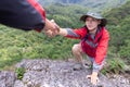 Young couple traveling, Helping hand, hiker woman getting help on hike smiling happy overcoming obstacle, Tourist backpackers Royalty Free Stock Photo