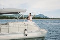 Young couple is traveling on a yacht in the Indian ocean. On the bow of the boat, a loving family takes selfie Royalty Free Stock Photo