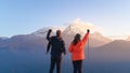 Young couple travellers trekking in Poon Hill view point in Ghorepani, Nepal