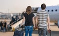 Young couple is travelling on vacation. Man and woman with baggage in airport Royalty Free Stock Photo