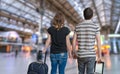 Young couple is travelling on vacation. Man and woman with baggage in train station Royalty Free Stock Photo