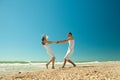 Young couple twirling on the beach