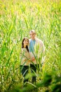 Young man and woman in Ukrainian shirts in a field with corn Royalty Free Stock Photo