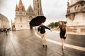 Young couple with umbrella walking in Budapest on a rainy day. Love story Royalty Free Stock Photo