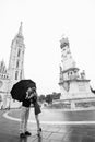 Young couple with umbrella walking in Budapest on a rainy day. Love story. Black and white Royalty Free Stock Photo