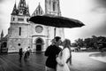 Young couple with umbrella walking in Budapest on a rainy day. Love story. Black and white Royalty Free Stock Photo