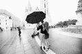 Young couple with umbrella walking in Budapest on a rainy day. Love story. Black and white Royalty Free Stock Photo