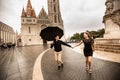 Young couple with umbrella walking in Budapest on a rainy day. Love story Royalty Free Stock Photo