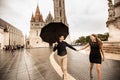 Young couple with umbrella walking in Budapest on a rainy day. Love story Royalty Free Stock Photo