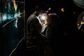 Young couple under an umbrella kisses at night on a city street. Royalty Free Stock Photo